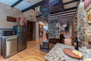 a kitchen with a refrigerator and a counter top at El Rincon De San Jose in Marjaliza