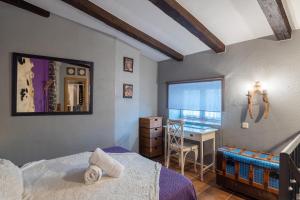 a bedroom with a bed and a desk at El Rincon De San Jose in Marjaliza