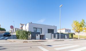 a white building on the side of a street at Jouvacations Villa Sol La Selva in Vilafant