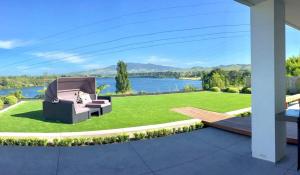 a garden with a view of a lake at Karapiro Lakeside in Karapiro