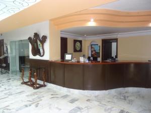 a lobby with a reception desk in a hotel at Hotel Maria Victoria Xalapa in Xalapa