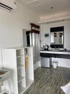 a white kitchen with a counter and a sink at Joy Houses Haadrin in Haad Rin +23 photos