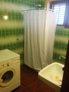 uma casa de banho verde com uma máquina de lavar roupa e um lavatório em Apartment Len Slovaci em Zadar
