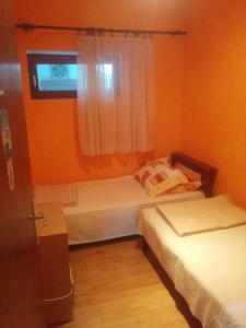 a small room with two beds and a window at Apartment Len Slovaci in Zadar