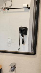 a reflection of a hair dryer in a bathroom mirror at Nima guest house in Nizwa
