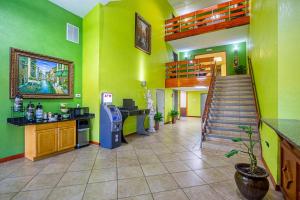 a lobby with green walls and a staircase in a building at Quality Inn & Suites near Six Flags East in Atlanta