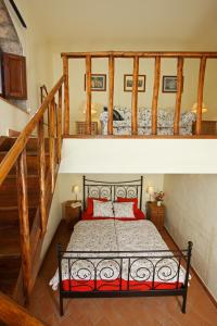 a bedroom with a bed in a room with stairs at Poggio Rozzi in Tavarnelle in Val di Pesa +17 photos