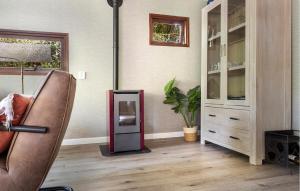 a living room with a refrigerator next to a chair at Amazing Home In Erm With Wifi in Erm