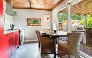 a kitchen with red cabinets and a wooden ceiling at Amazing Home In Erm With Wifi in Erm