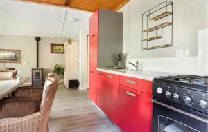 a kitchen with red cabinets and a stove at Amazing Home In Erm With Wifi in Erm +23 photos