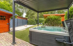 a hot tub under a pergola in a backyard at 1 Bedroom Stunning Home In Erm in Erm +26 photos