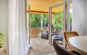 a dining room with a sliding glass door to a deck at 1 Bedroom Stunning Home In Erm in Erm