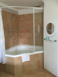 a bath tub in a bathroom with a shower at The Nosh & Nod - Avon Terrace in York