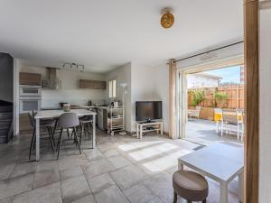 a kitchen and living room with a table and chairs at Maison spacieuse à Biscarrosse-Plage près de l'océan - FR-1-521-251 in Biscarrosse