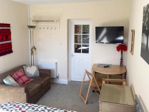 a living room with a couch and a table at High Banks studio in Sevenoaks