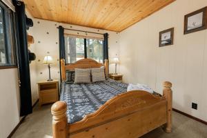 a bedroom with a wooden bed in a room at Bear Woods 3BR Retreat in Big Bear City