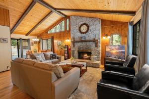 a living room with a couch and a fireplace at Bear Woods 3BR Retreat in Big Bear City