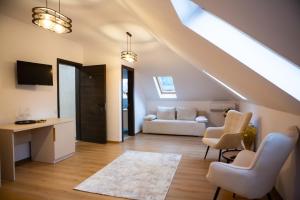 a living room with a couch and a table and chairs at Nico Pardon Select in Câmpulung