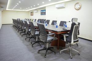 a conference room with a long table and chairs at The Monterey Grand Hotel in Lahore