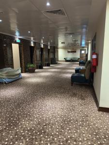 a long hallway of a hospital with couches and chairs at Al Khaleej Palace Deira Hotel in Dubai