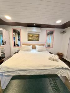 a large bed in the middle of a room at Independent Studio 25 Corner House Bandra west in Mumbai