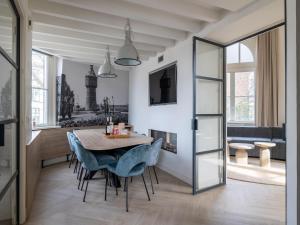 a dining room with a table and chairs at Renovated luxury water tower within walking distance of the beach boulevard in Vlissingen
