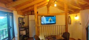 a living room with a television on a wall at Casa abuelo Kalinas in Cazorla