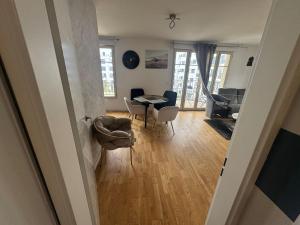 a view of a living room with a table and chairs at Building carré d eden in Clamart