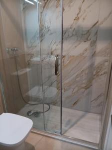 a shower with a glass door in a bathroom at Arenas de Plata Atlanterra in Zahara de los Atunes