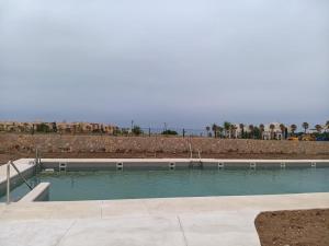 a swimming pool with the ocean in the background at Arenas de Plata Atlanterra in Zahara de los Atunes