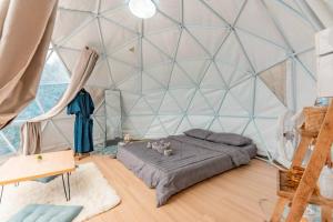 a room with a bed in a large tent at Phupetra in Ban Thung Phan Ha