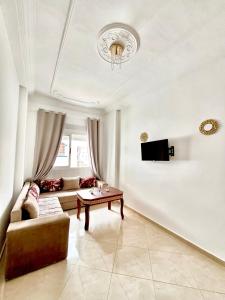 a living room with a couch and a table at Blue Pearl Apartments in Chefchaouene