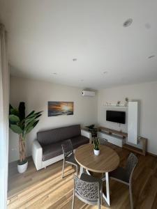a living room with a couch and a table at SICILIA FIERA Apartment in Misterbianco