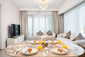 a living room with a table with plates of food on it at Executive 2-Bedroom Apartment in Downtown views 2 with access to Dubai mall in Dubai