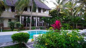 a house with a swimming pool in front of a house at kings private villa in Gatunga
