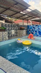 a swimming pool with two frisbees in the water at Fahim Homestay Pasir Mas in Pasir Mas