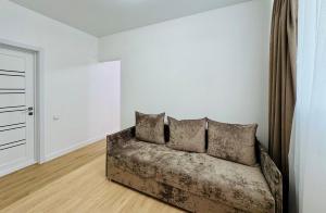 a couch in a room with white walls at CehovHouse in Bălţi
