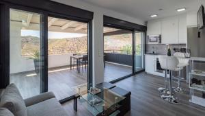 a living room with a couch and a table at Villa Alborada Torrox by Ruralidays in Torrox +20 photos