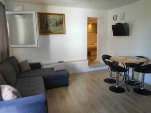 a living room with a couch and a table at Apartman Petra in Trpanj