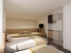 a bedroom with a large bed and a kitchen at Tosei Hotel Cocone Kamata in Tokyo