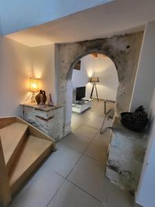 a view of a living room with a stone wall at Maison en pierre rénovée in Taïx