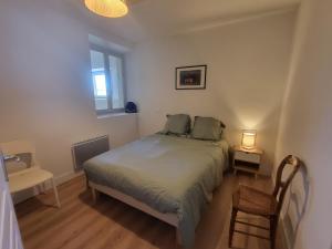 a small bedroom with a bed and a window at Maison en pierre rénovée in Taïx