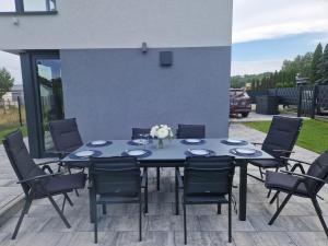 a blue table and chairs on a patio at Villa Seaview in Nadole +20 photos