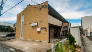 a brick building with a staircase on the side of it at apartment hotel myu 郡山 in Koriyama
