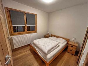 a small bedroom with a bed and a window at Appartement aux Saisies, 62m², 7 pers, 3 étoiles, Parking inclus - FR-1-293-411 in Les Saisies