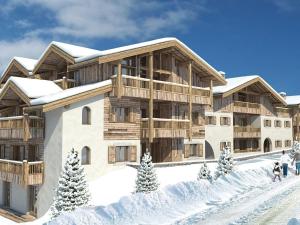 a building in the snow with people walking in front of it at Appartement aux Saisies, 62m², 7 pers, 3 étoiles, Parking inclus - FR-1-293-411 in Les Saisies