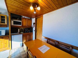 a kitchen with a wooden table in a kitchen at Studio Cabine Les Saisies, 4 pers, Terrasse sud - FR-1-293-413 in Les Saisies