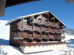 a large wooden building with animals in the snow at Studio Cabine Les Saisies, 4 pers, Terrasse sud - FR-1-293-413 in Les Saisies +5 photos