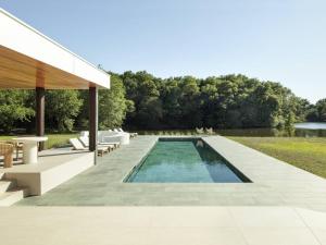 a swimming pool in a yard with a house at Villa Luxe au Cœur des Landes - Architecture d'Exception - FR-1-791-43 in Magescq +24 photos