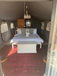 a bedroom with a bed in a tent at Khaya Ndlovu Safari Manor in Hoedspruit